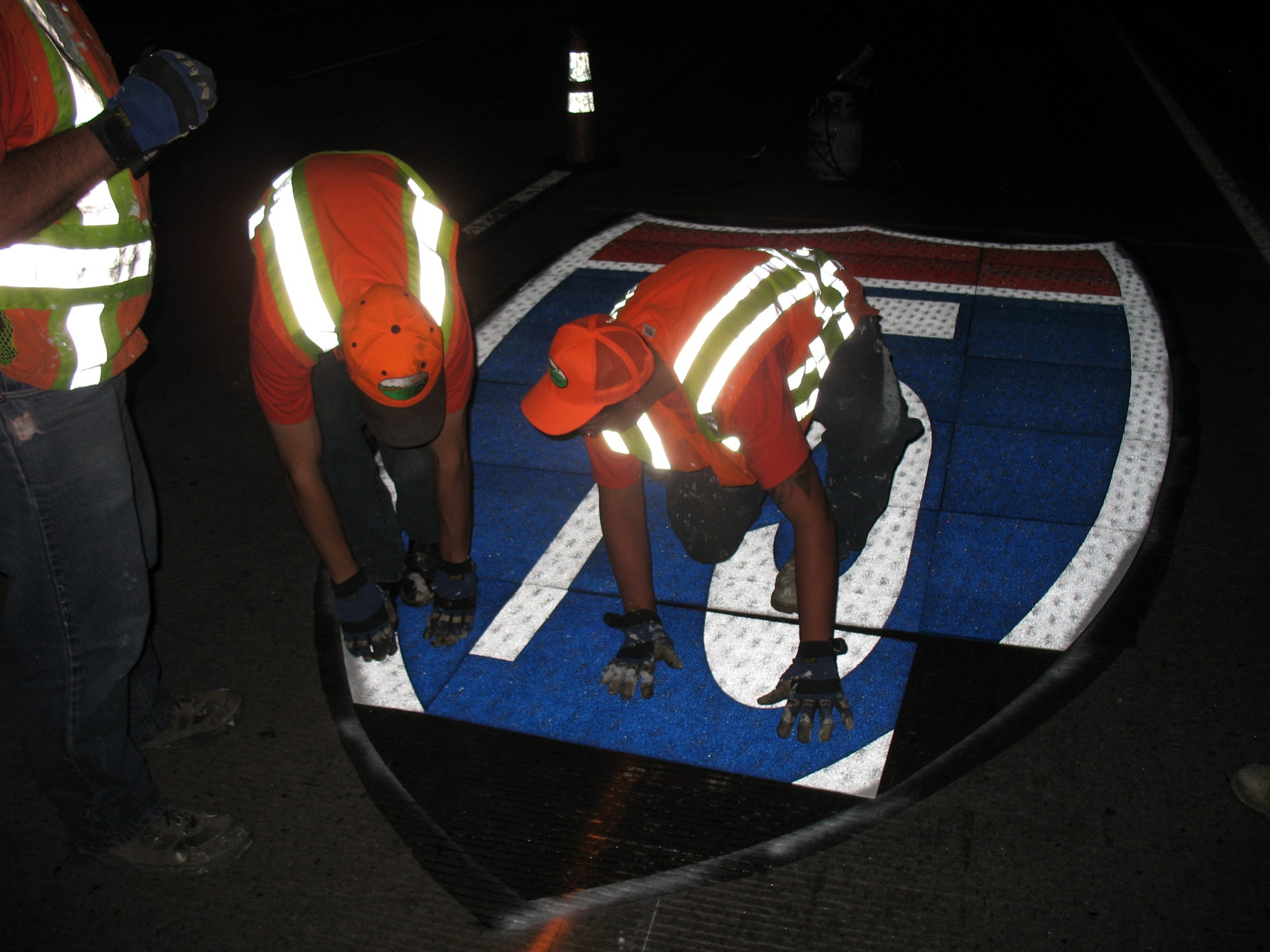 Crew placing I-15 shield pavement message photo