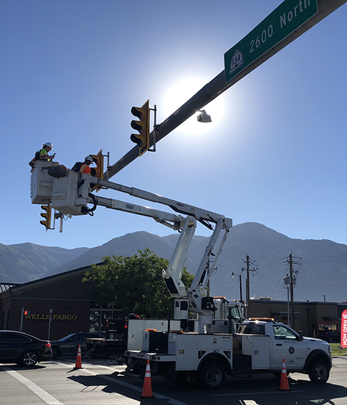 Photo of crews in bucket truck installing heat tape