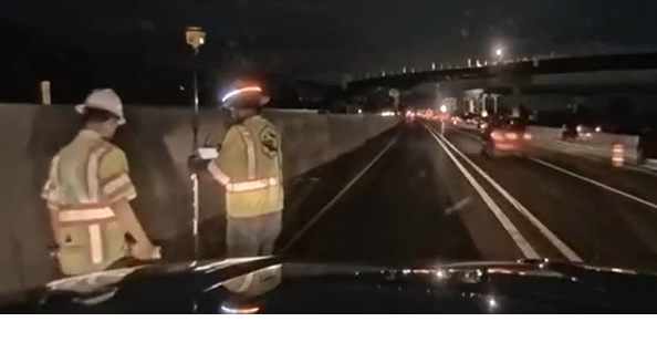 Dash camera image of crew and driver in closed lanes