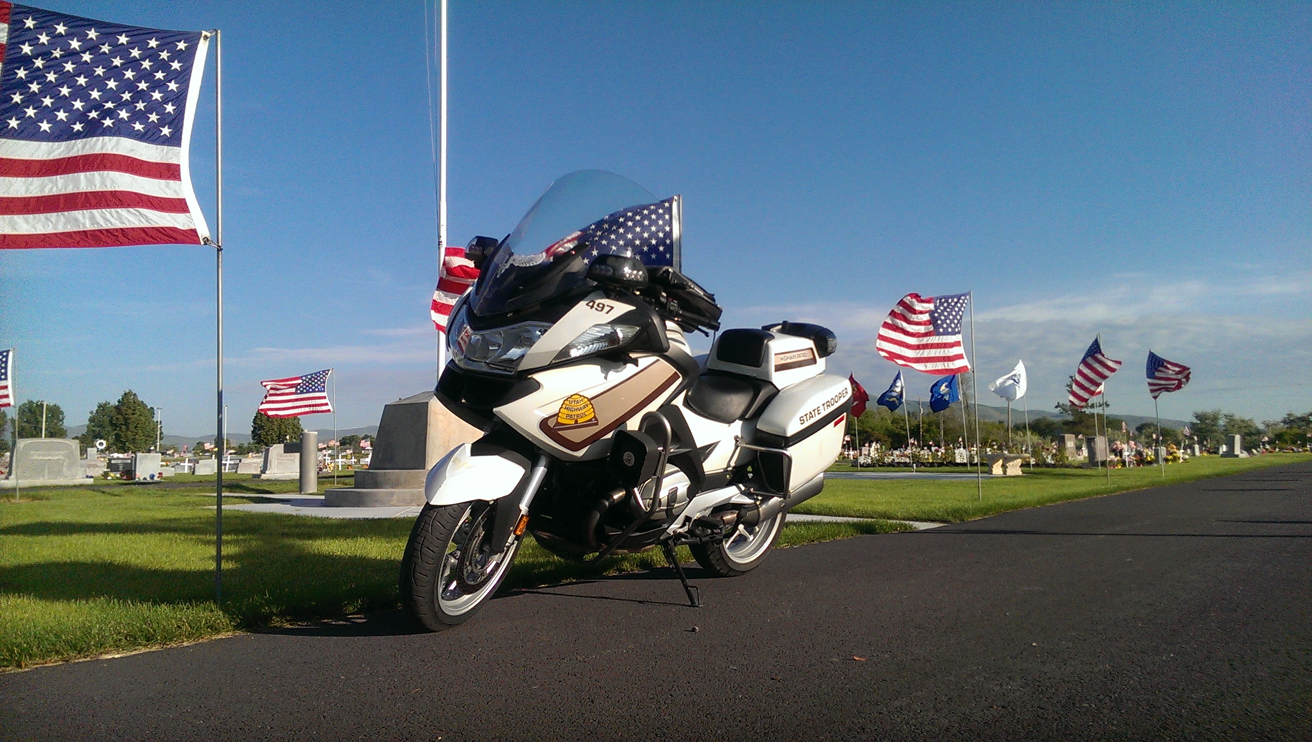 UHP motorcycle parked near flags on Memorial Day 2016