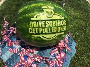 watermelon with the Drive Sober or Get Pulled Over logo carved into it