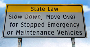 Slow down and move over for emergency vehicles freeway sign