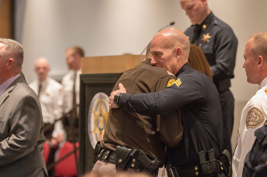 Sgt. Lauritzen embraces a graduating UHP trooper