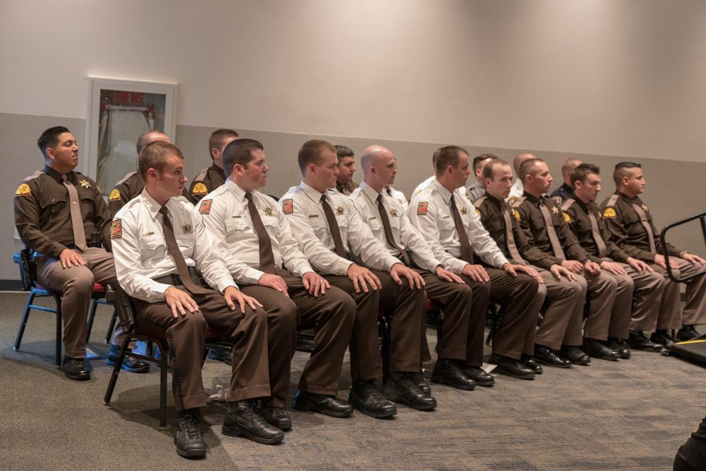 Officers listen to speakers at POST graduation