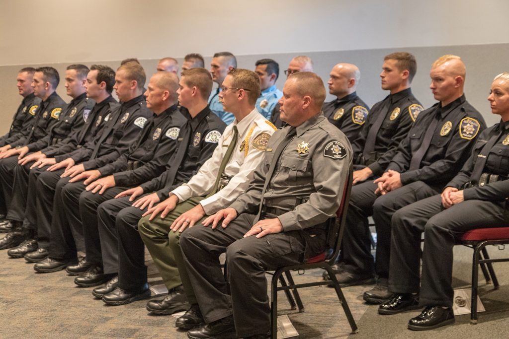 Officers listen to speakers at POST graduation