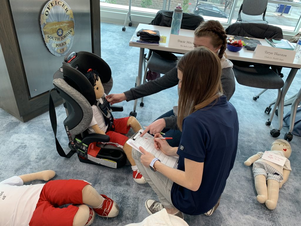 Instructor reviews car seat choice and fit with a student.