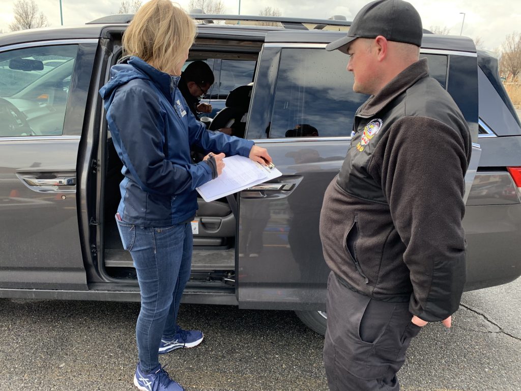 CPS Instructor discusses correct car seat installation with a student.